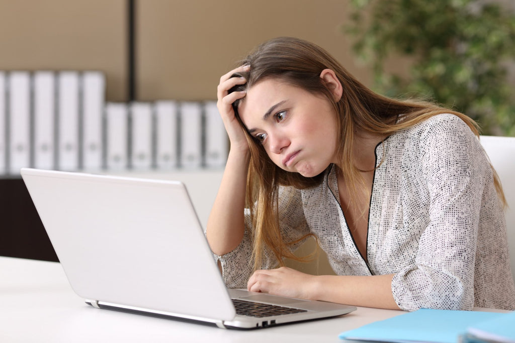 Woman struggling with an email issue on her laptop