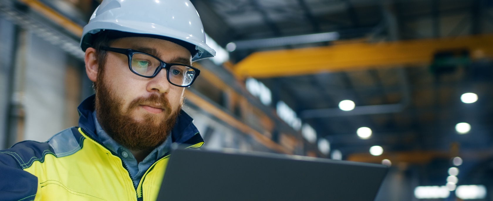 Mechanical contractor on site usng a laptop