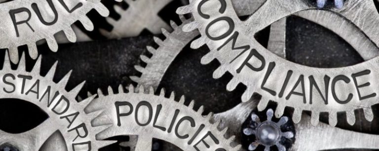 Cogs with compliance, policies, rules written on them.