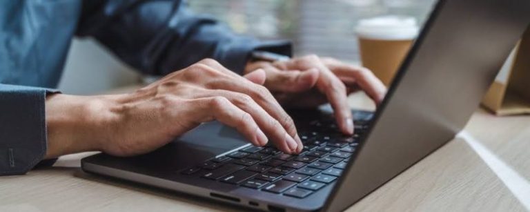 Typing on a laptop