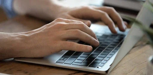 Typing on a laptop